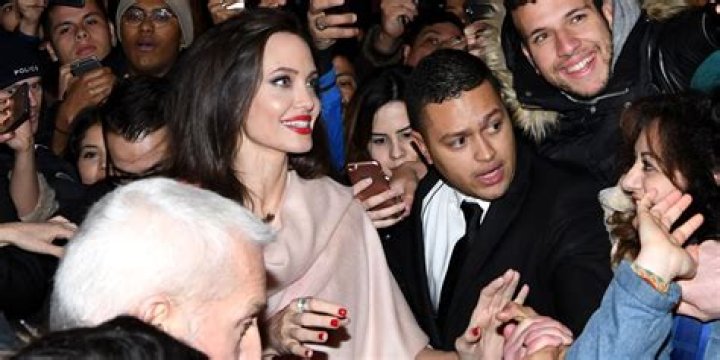 Angelina Jolie swarmed by fans & paparazzi at the Guerlain boutique in Paris