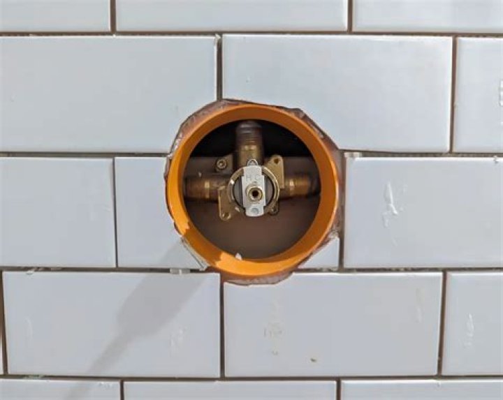 How do you cut tile around a shower valve?