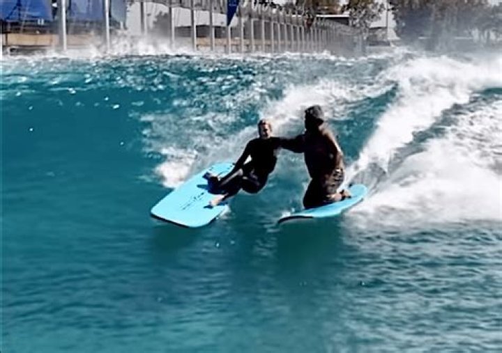 Prince Harry posed with surfers Kelly Slater & Raimana Van Bastolaer at the F1 race